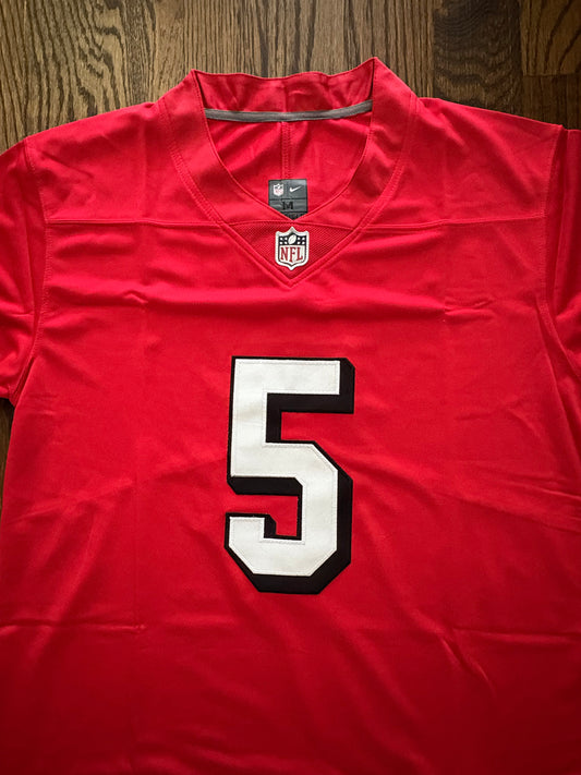 Red sports jersey with number 5 on a wooden surface